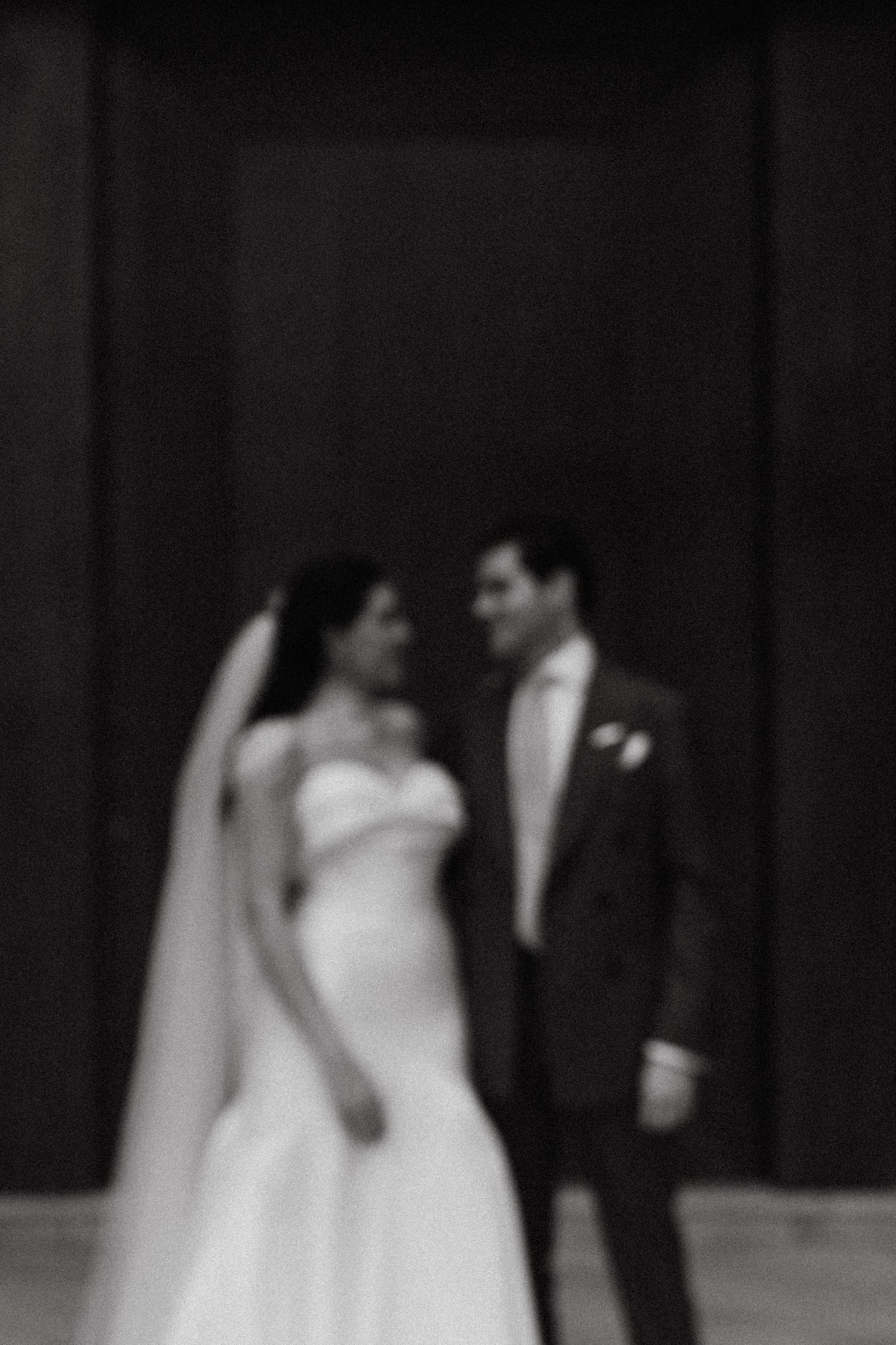 An artistic blurred black and white portrait of newlyweds.