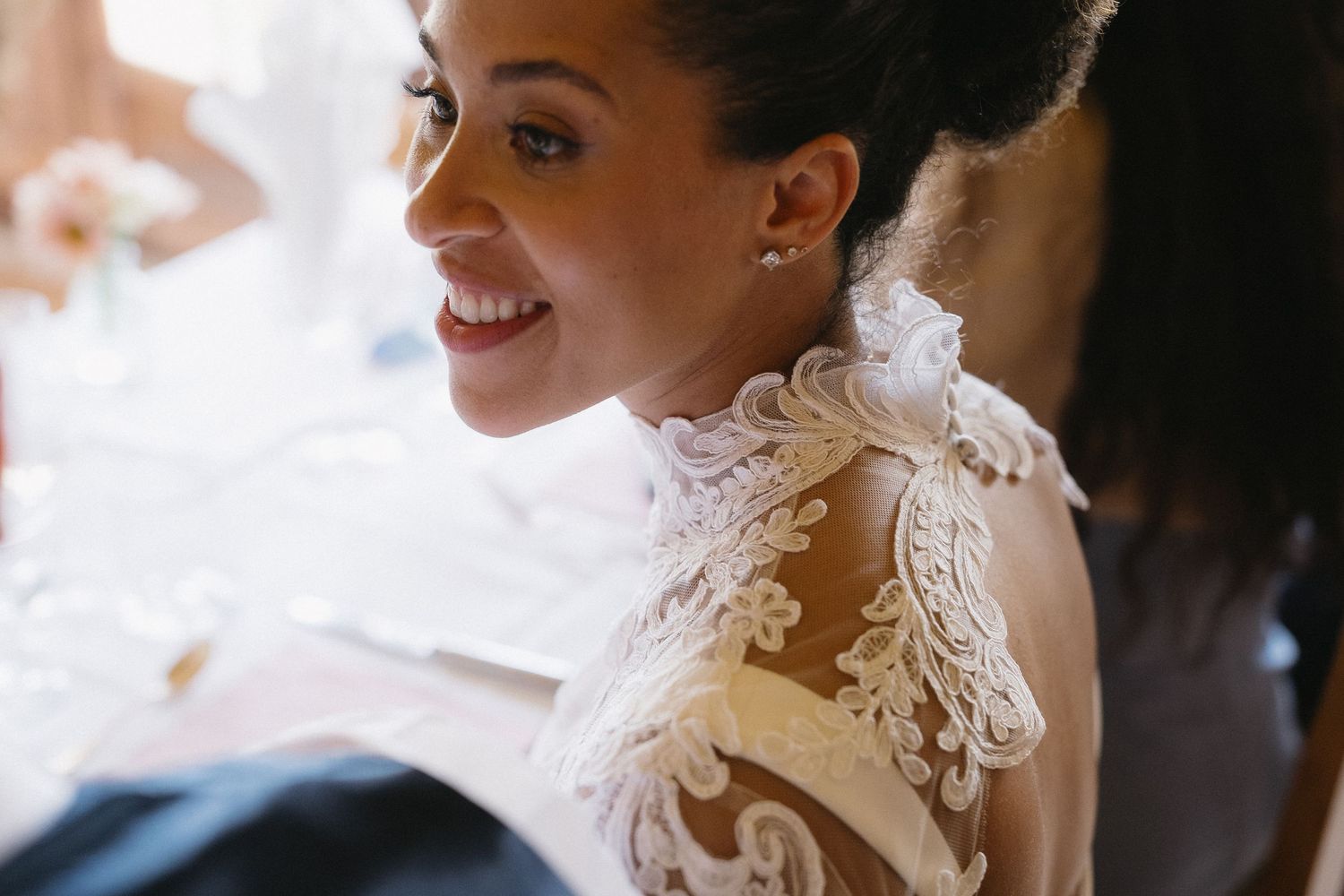 Close-up of delicate lace details on a white wedding dress.