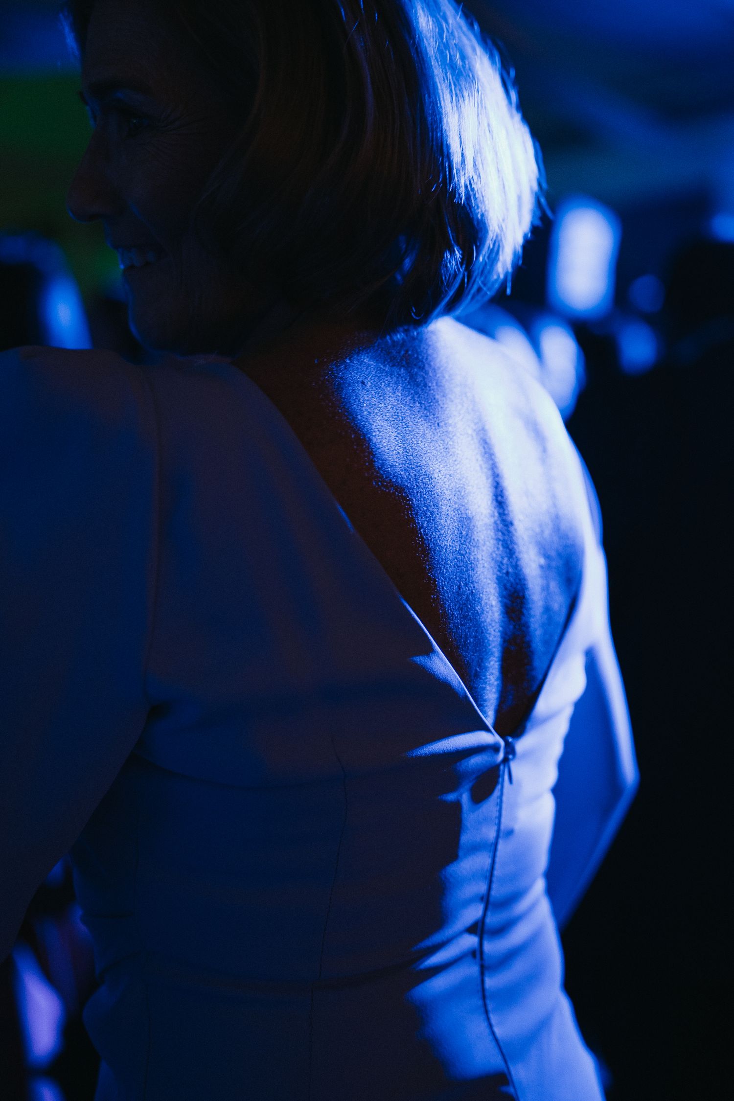 Abstract blue-tinted close-up photograph showing fabric texture and lighting effects.