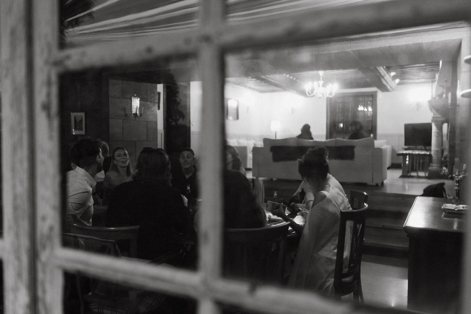 Dimly lit interior space with blurred movement captured in black and white.