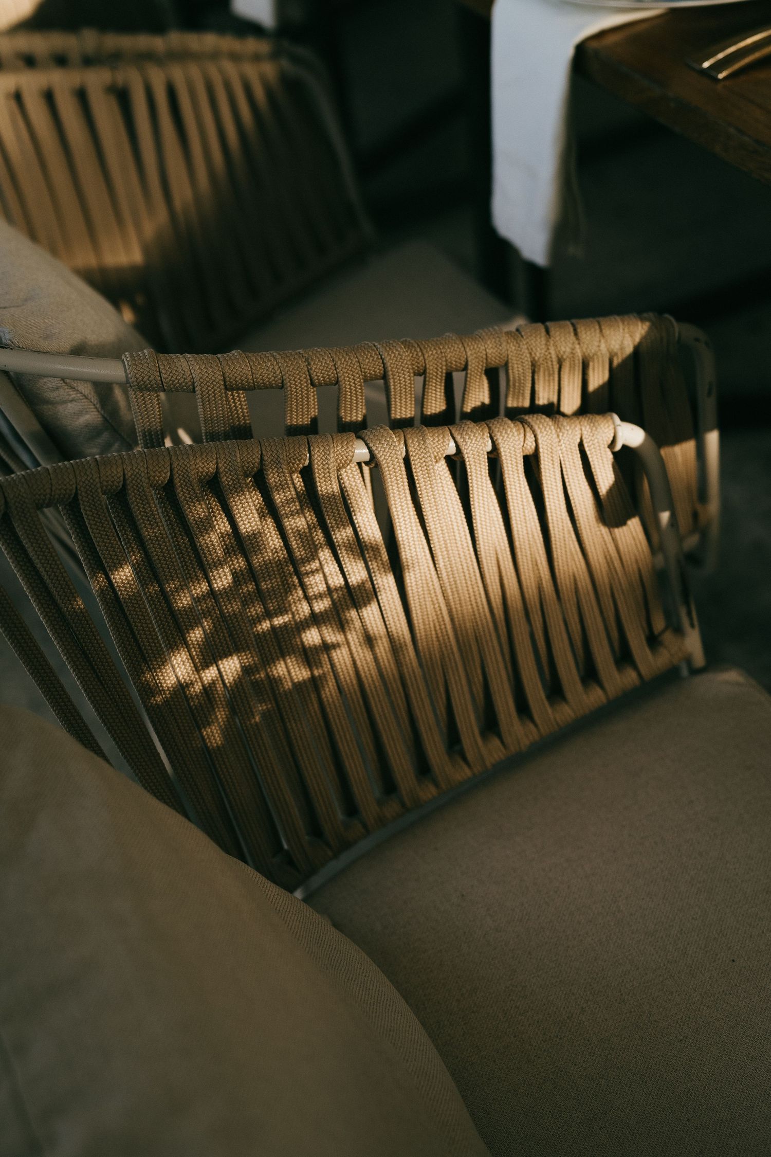 Dark wooden slats create dramatic shadows and patterns in an architectural detail.