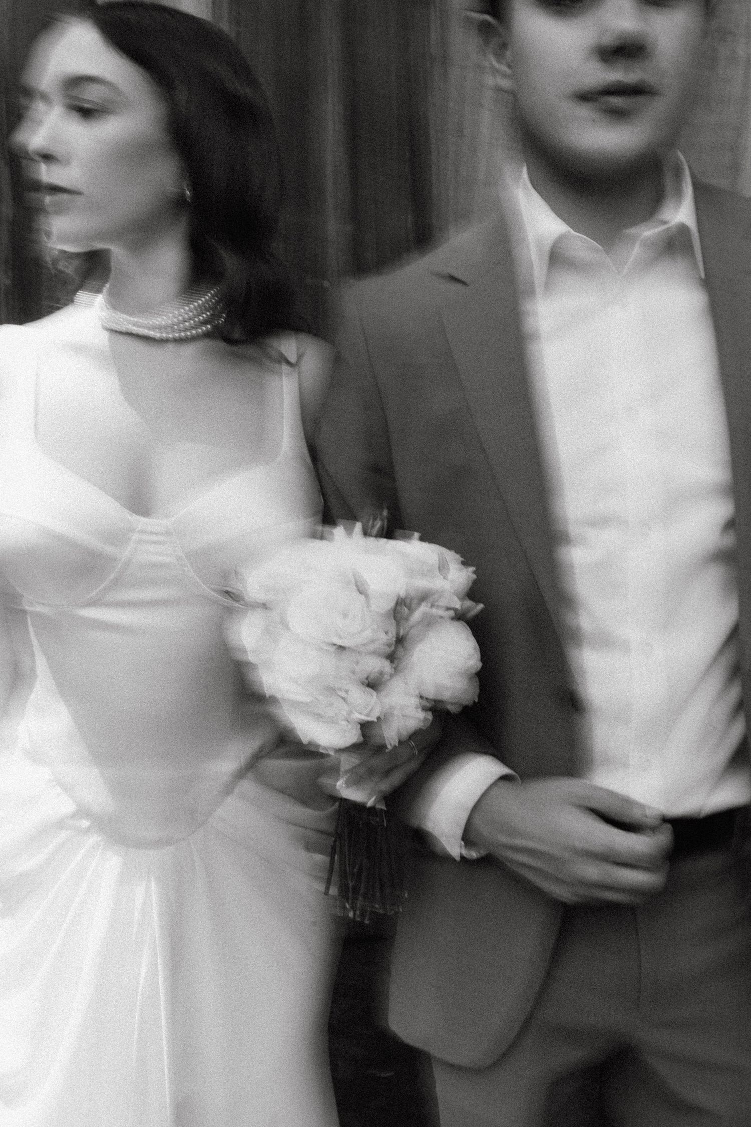 Motion-blurred black and white photos capturing romantic wedding moments.