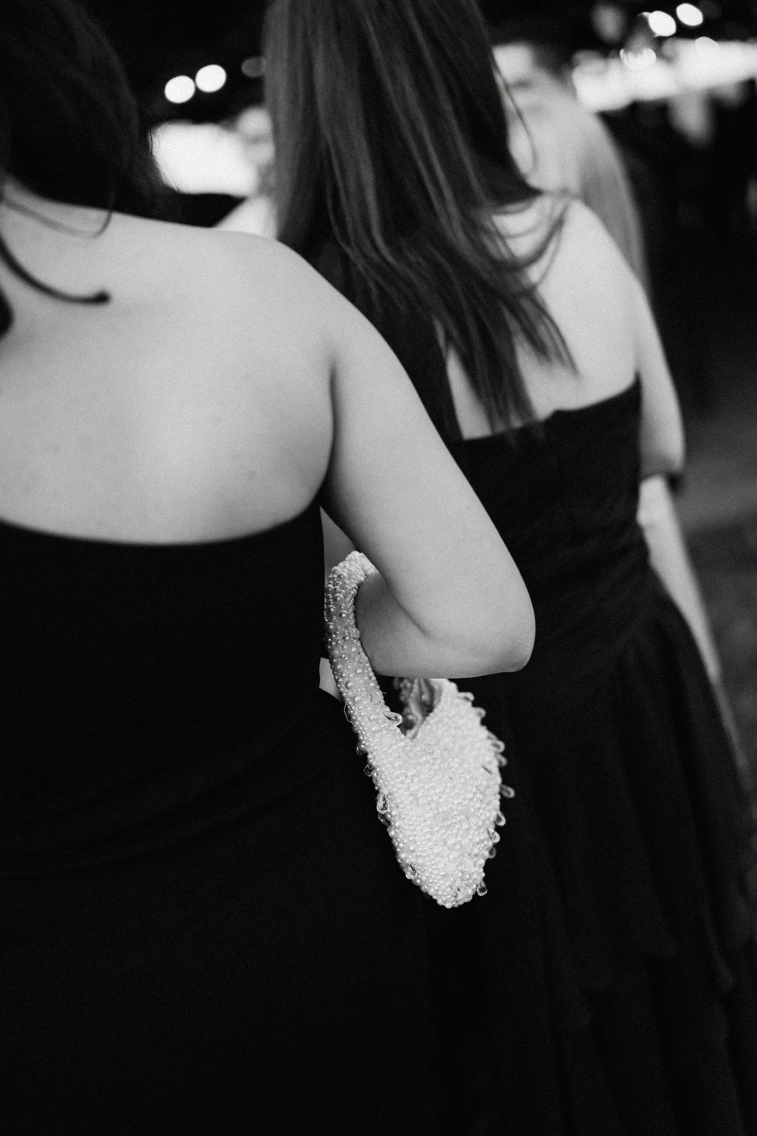 Black and white detail shot of formal evening wear with beaded embellishments.