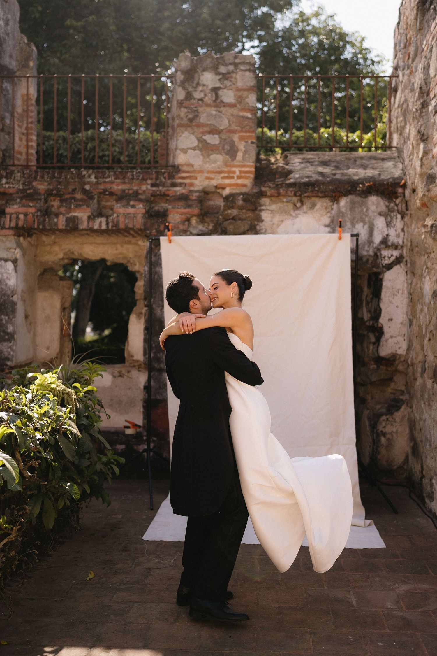 Romantic dance sequence against white backdrop and stone ruins.