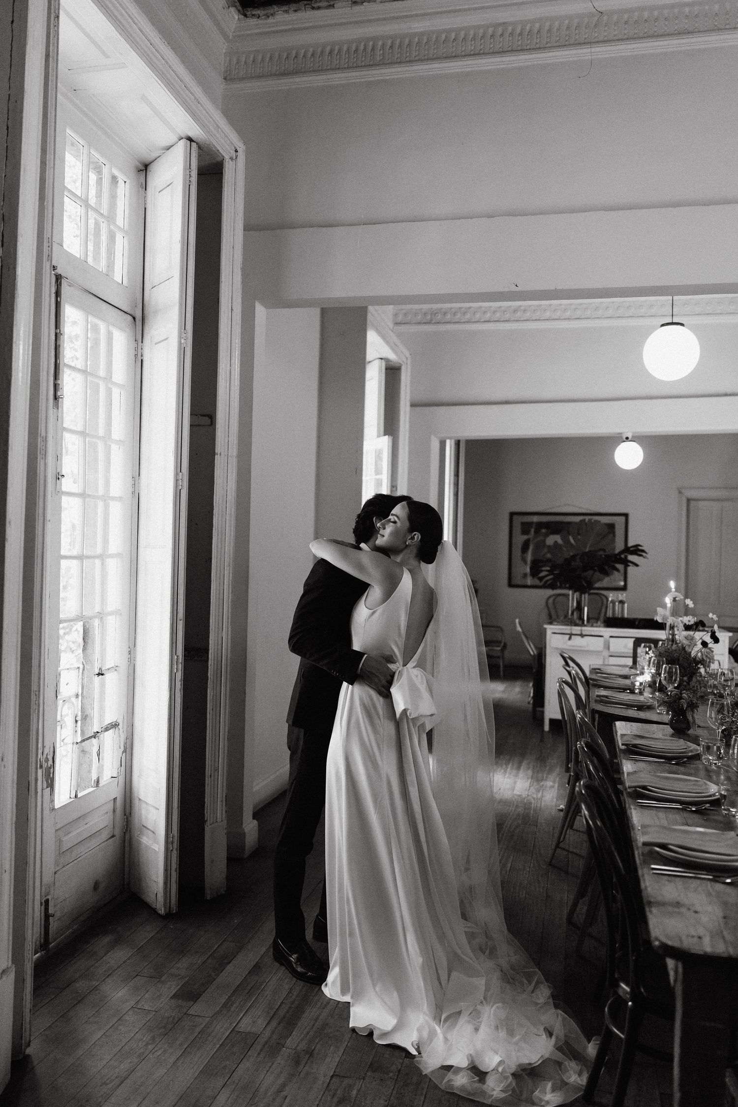 Black and white wedding photographs taken in a bright interior space.