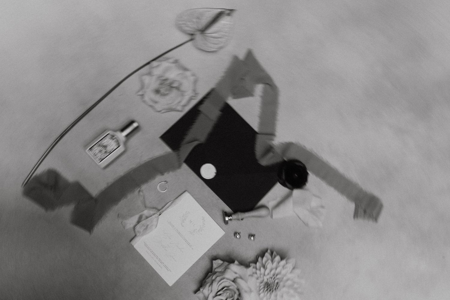 Vintage-style black and white photograph of wedding details from above.