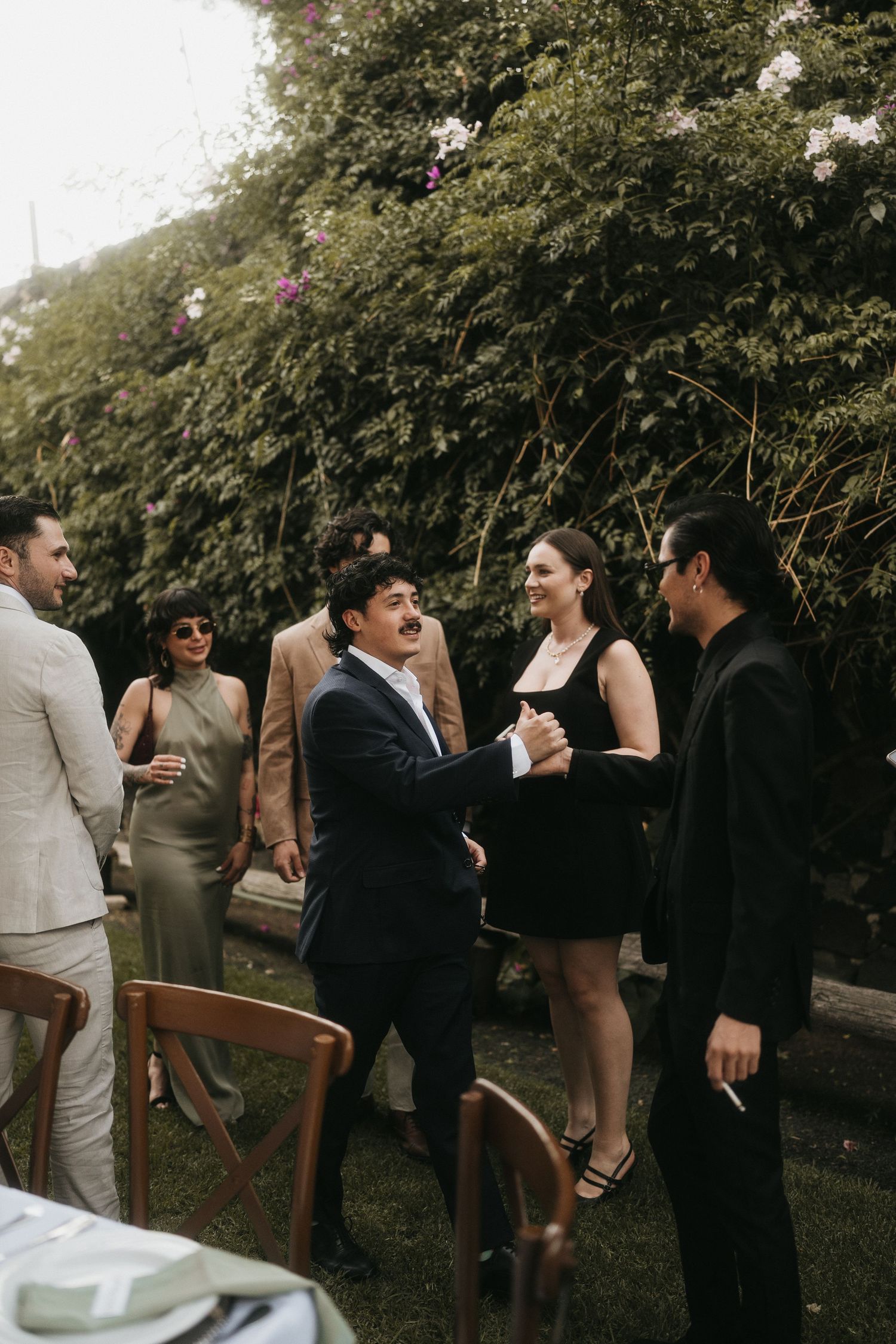 Wedding guests mingling at an outdoor cocktail reception.