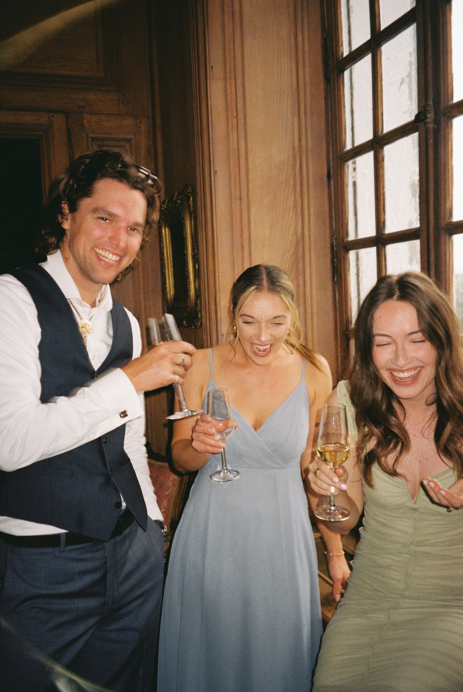 A series of candid photos showing friends laughing and toasting with champagne glasses in an elegant indoor setting.