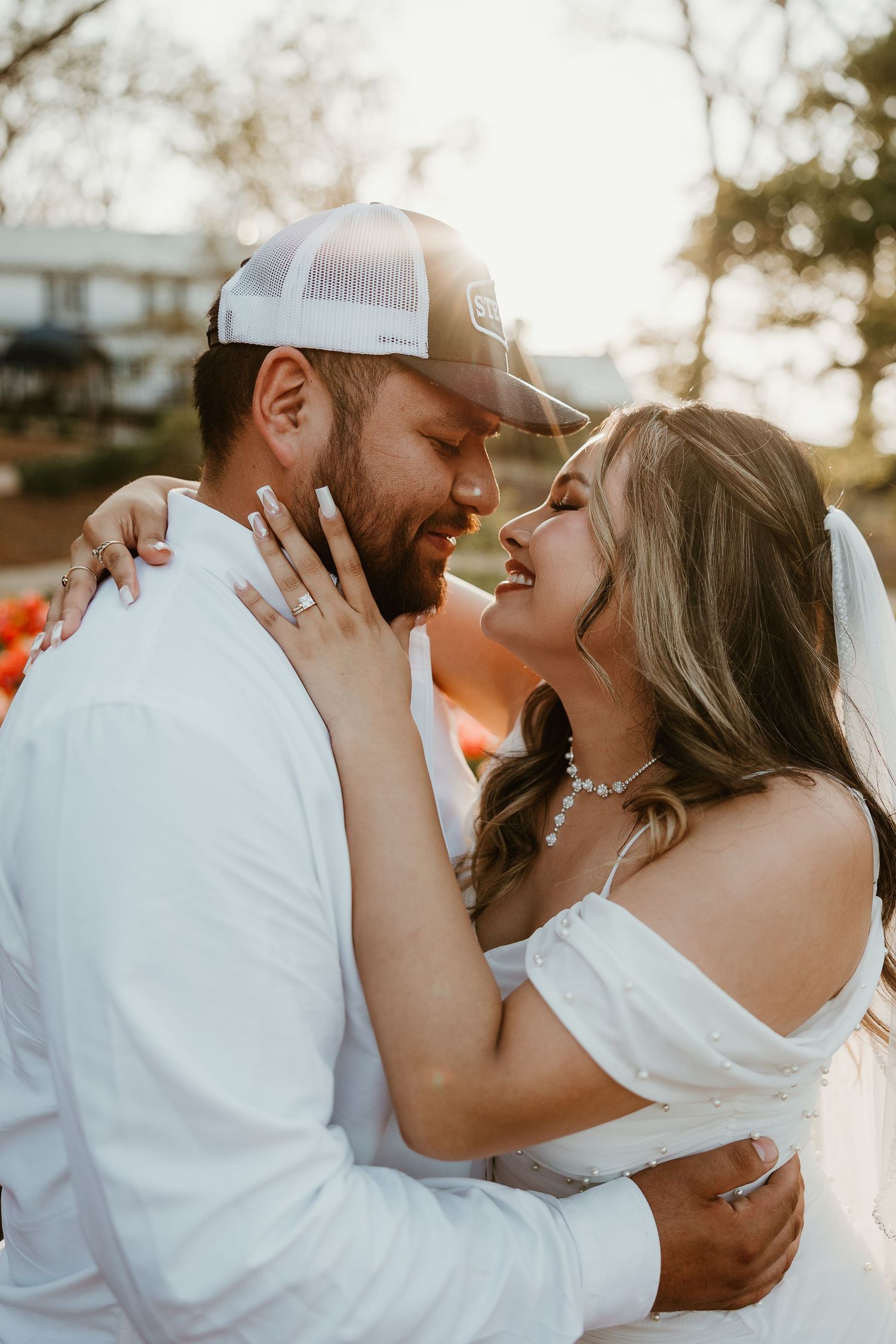 Romantic wedding portraits with couple in white sharing intimate moments outdoors.