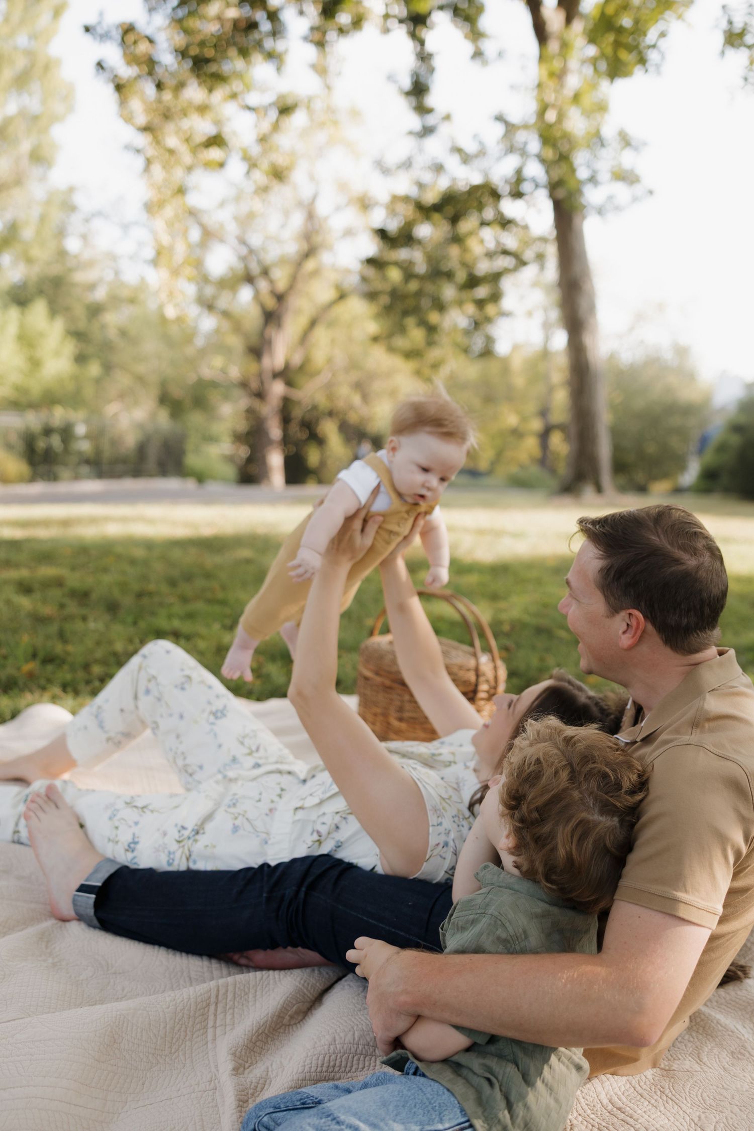 A playful sequence of family moments captured on a white blanket outdoors in autumn.