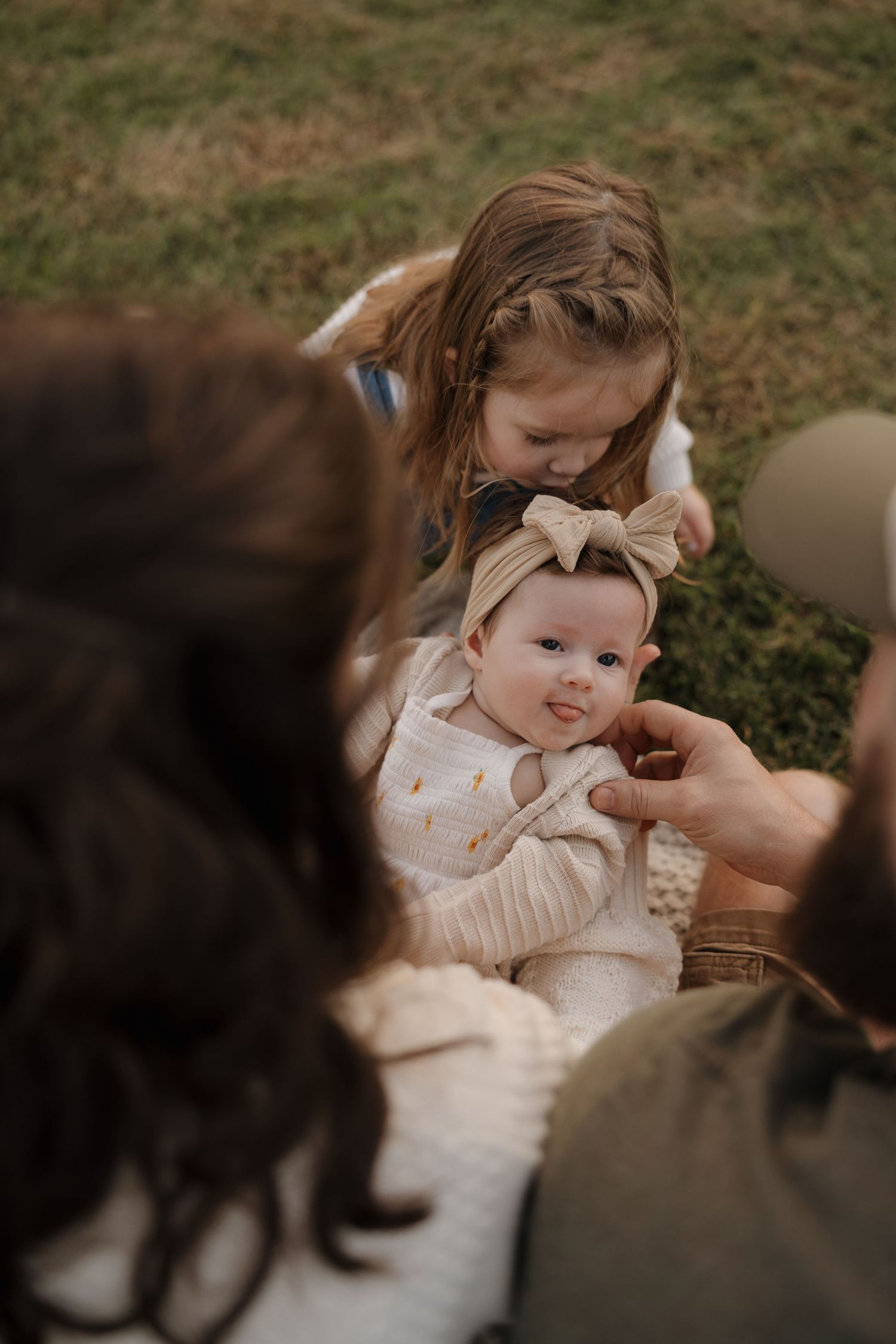 A series of intimate family moments captured in warm, earthy tones showing tender interactions between parent and baby.