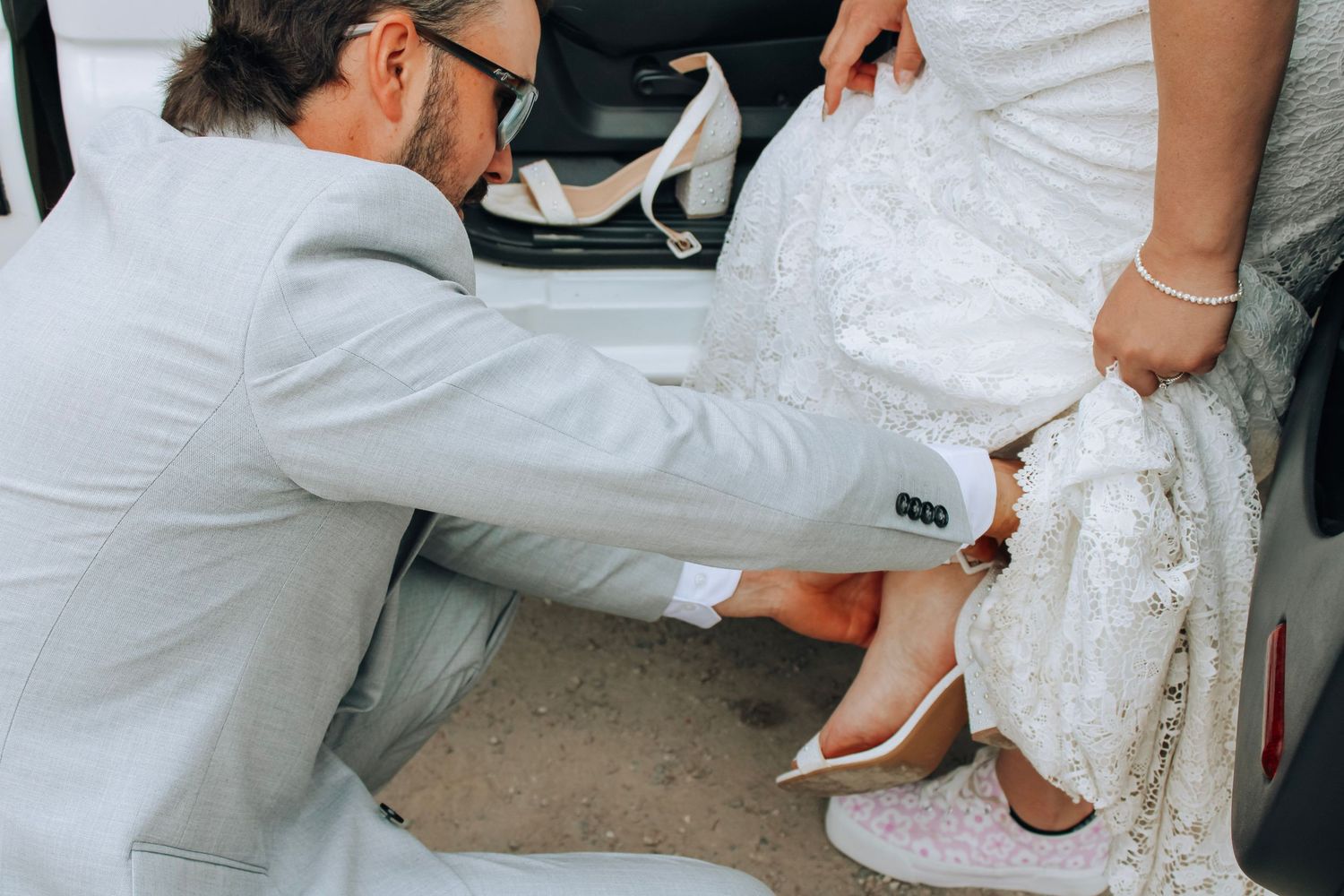 Close-up shots of wedding dress details and footwear during an outdoor ceremony.
