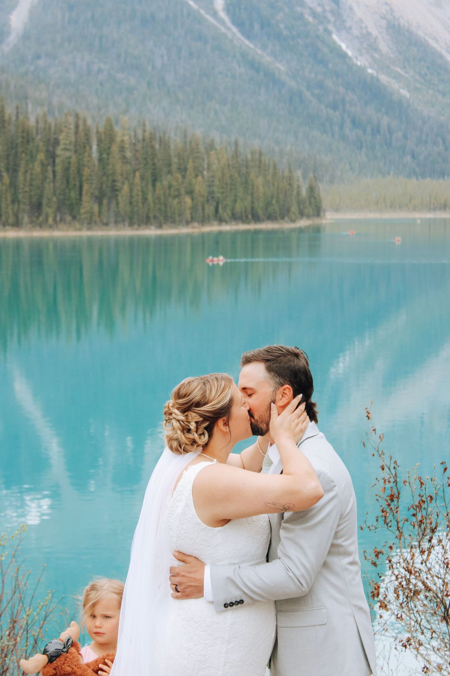 Wedding ceremony by a pristine mountain lake with snow-capped peaks in the distance.