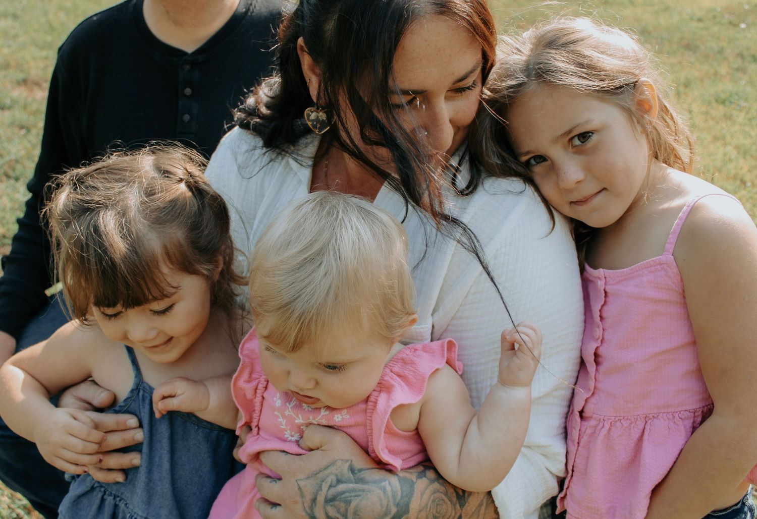 Intimate group portrait captured in soft natural lighting against mountain backdrop.