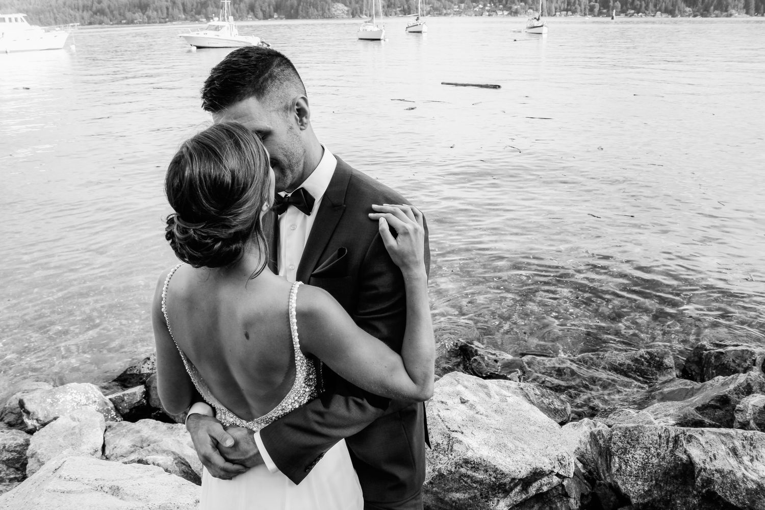 Series of black and white waterfront photos showing intimate moments between a couple.