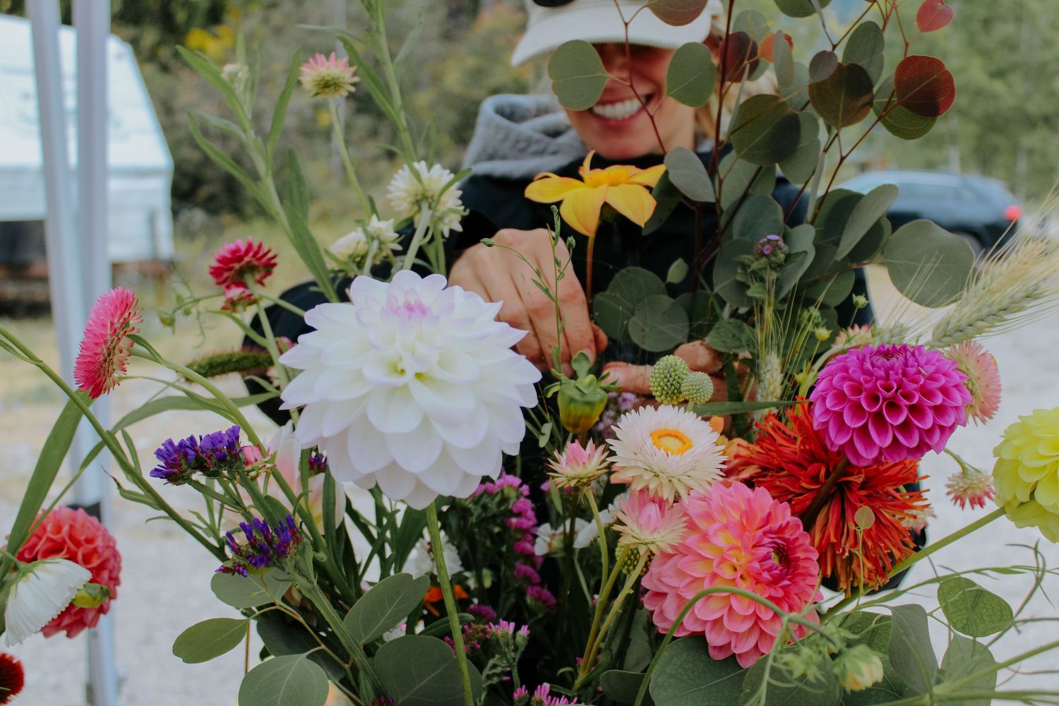 Close-up of freshly harvested dahlias and mixed flowers in various shades of pink and orange.
