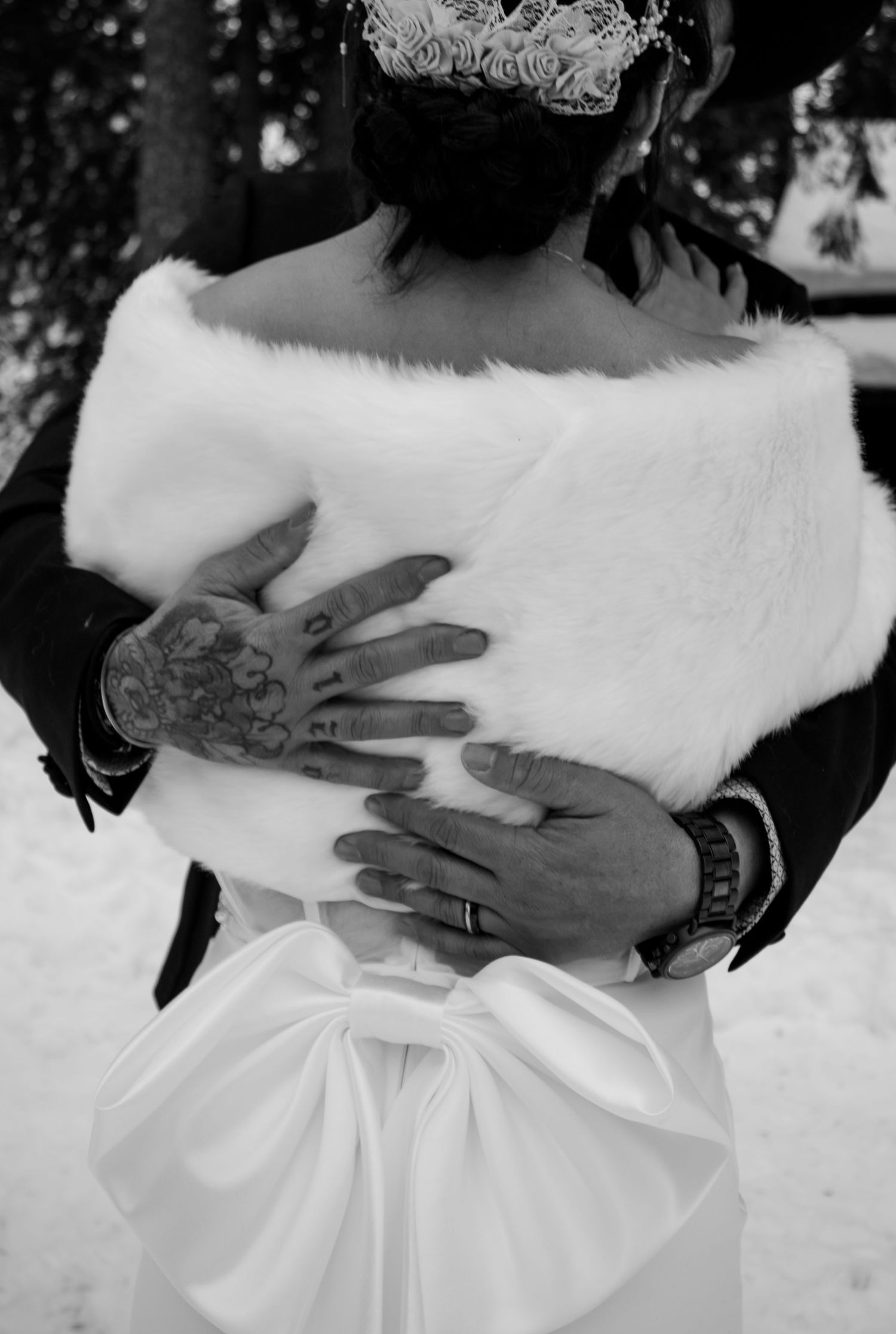 A sequence of black and white photos showing hands holding and caressing a white fur stole or wrap against dark clothing.
