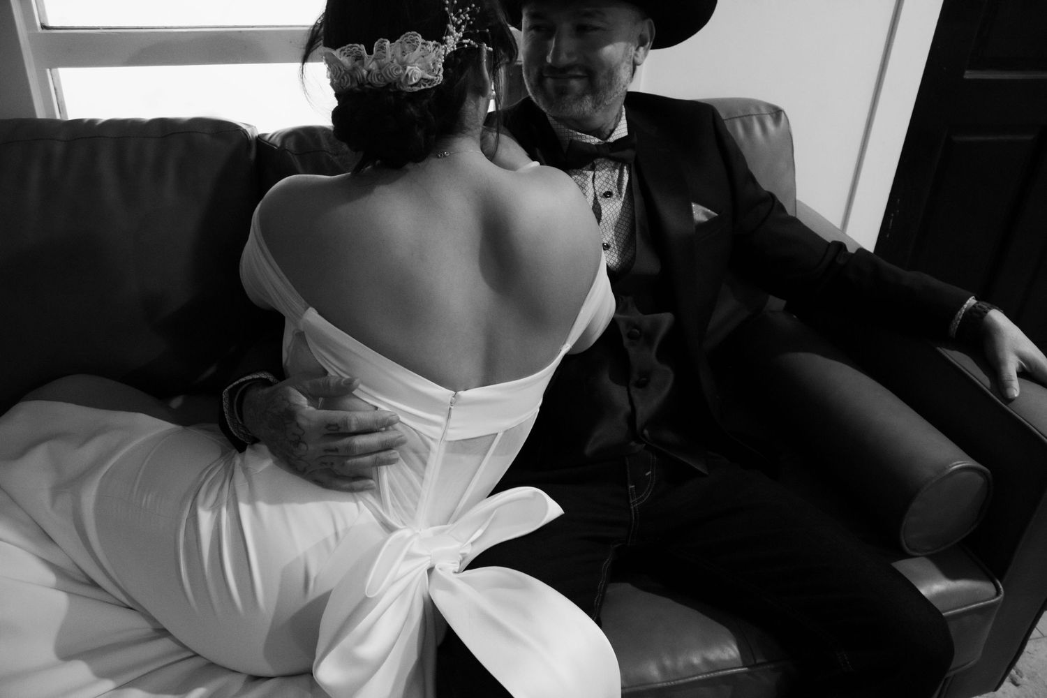 A series of black and white photographs showing tender moments between a couple on their wedding day.