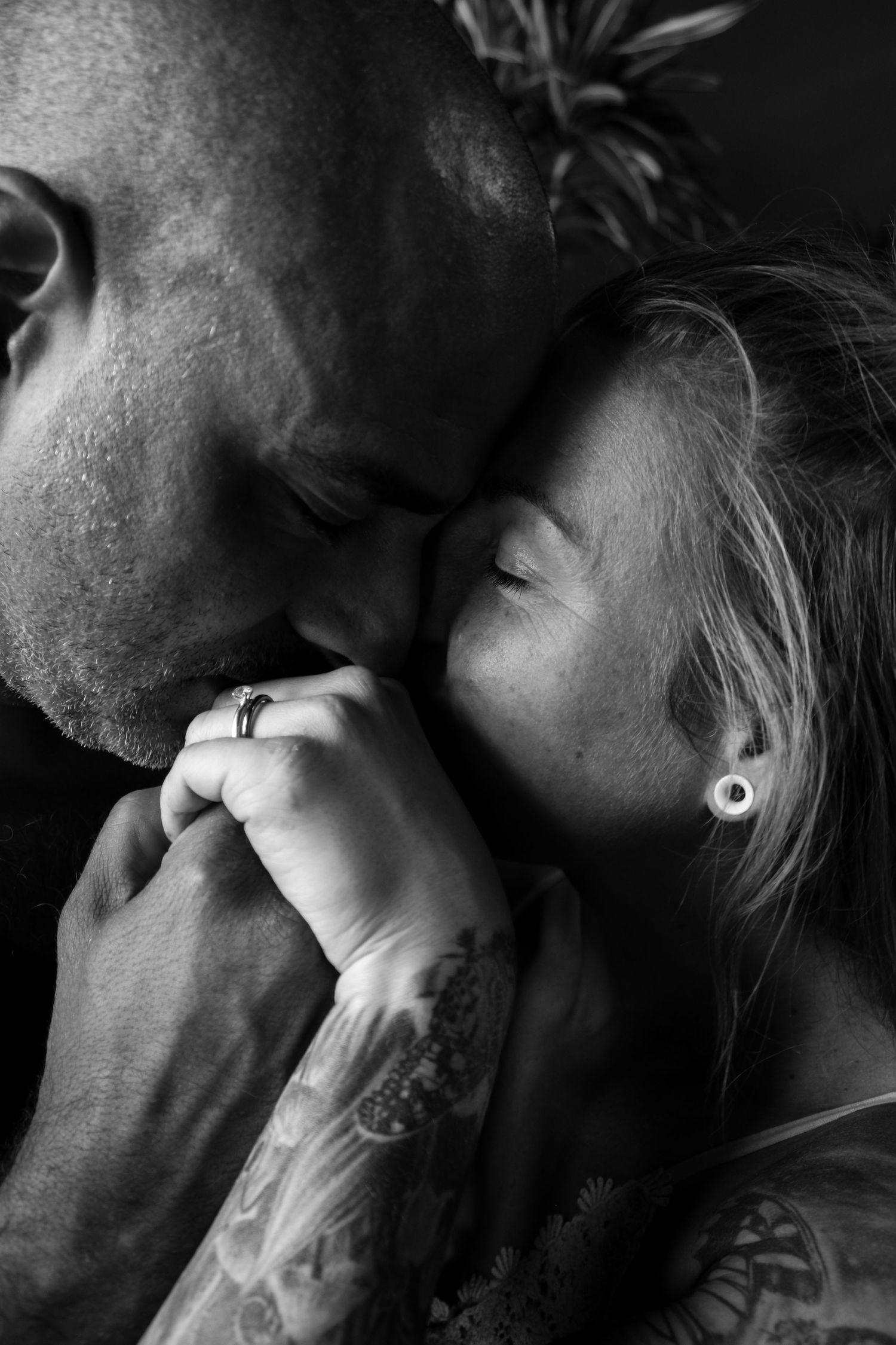 Close-up black and white portraits capturing intimate moments between a couple.