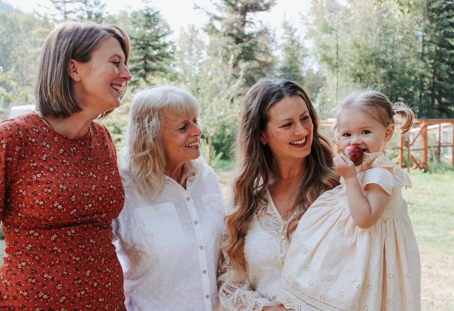 A casual family gathering outdoors wearing coordinated white and red outfits.