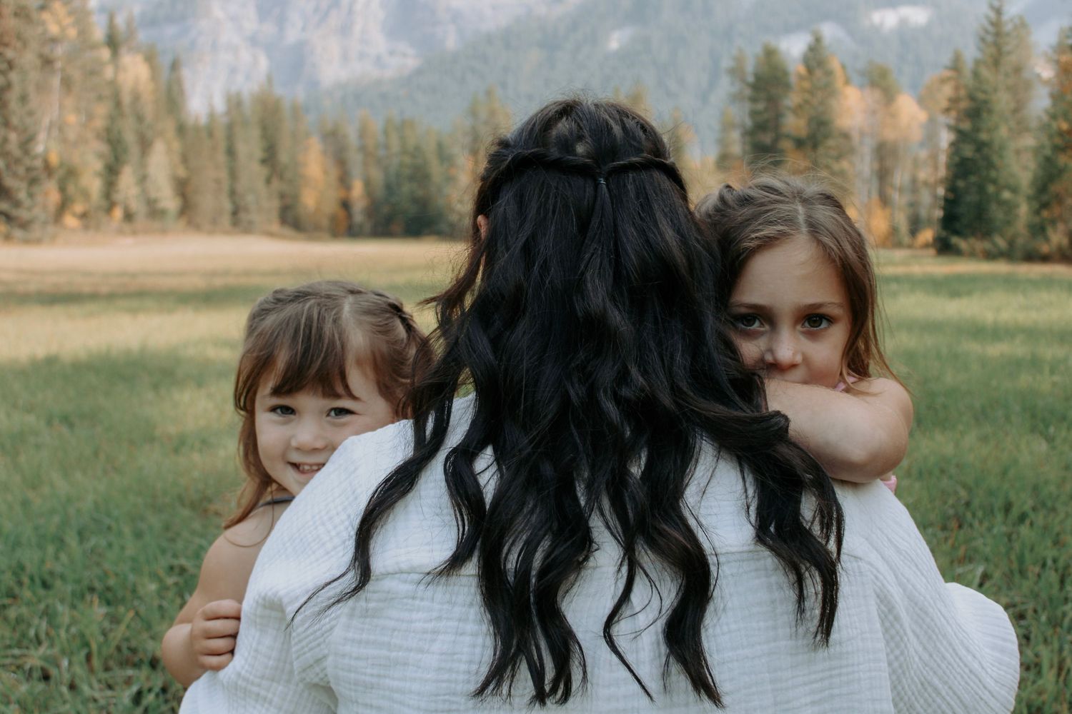 Natural candid moments shared between family members in mountain setting.