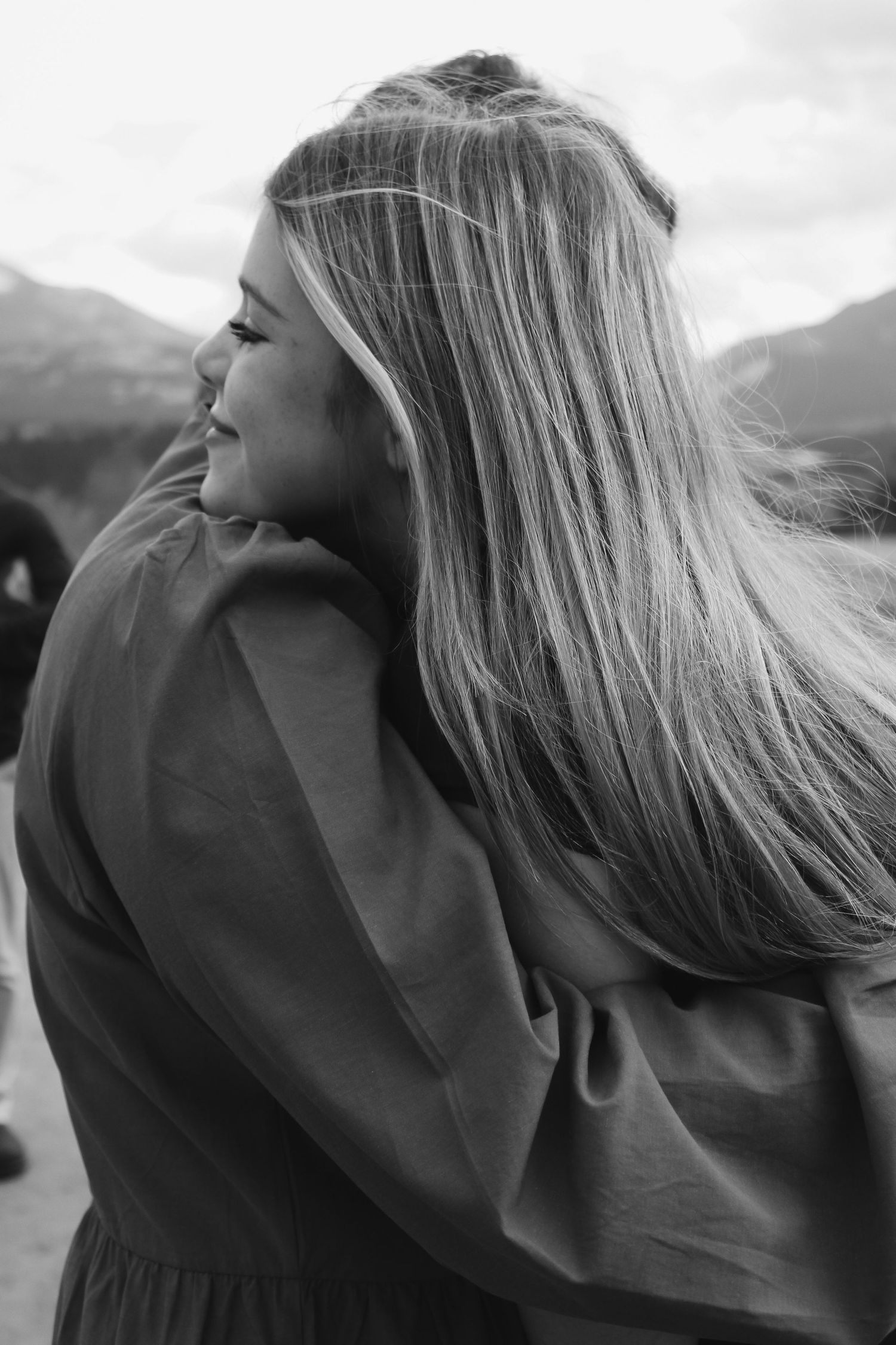 Series of candid moments captured in black and white against mountain scenery.