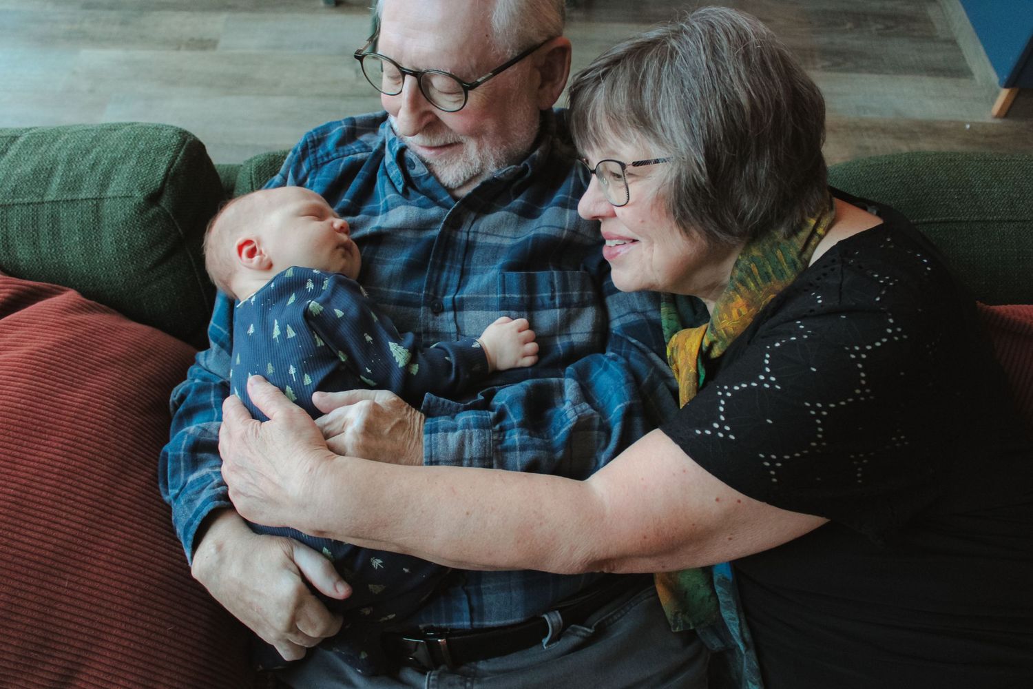 Candid family moments captured during indoor gathering with warm lighting.