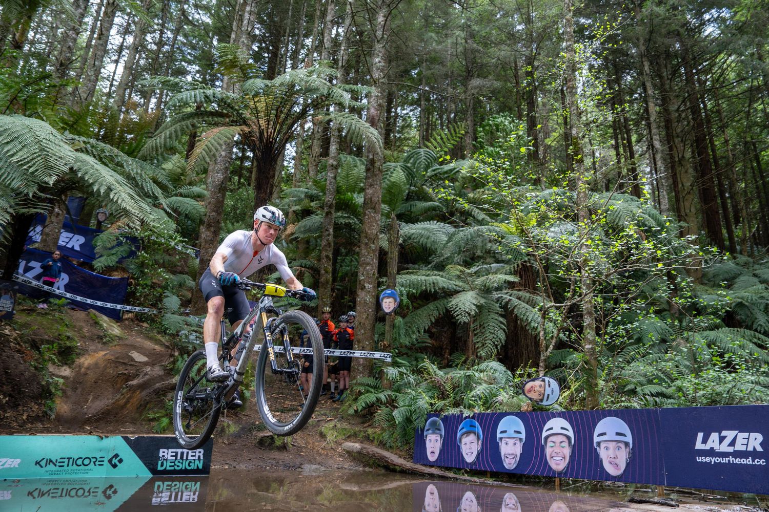 Mountain biker jumping the river crossing at The Wahaka 100 mountain bike race in Rotorua, New Zealand.