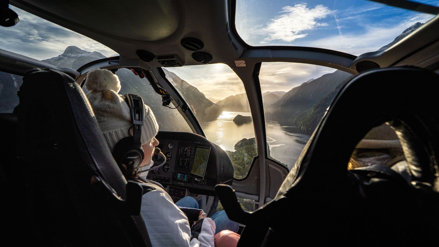 Family taking in the views from a helicopter flying over Doubtful Sound Fiordland National Park.