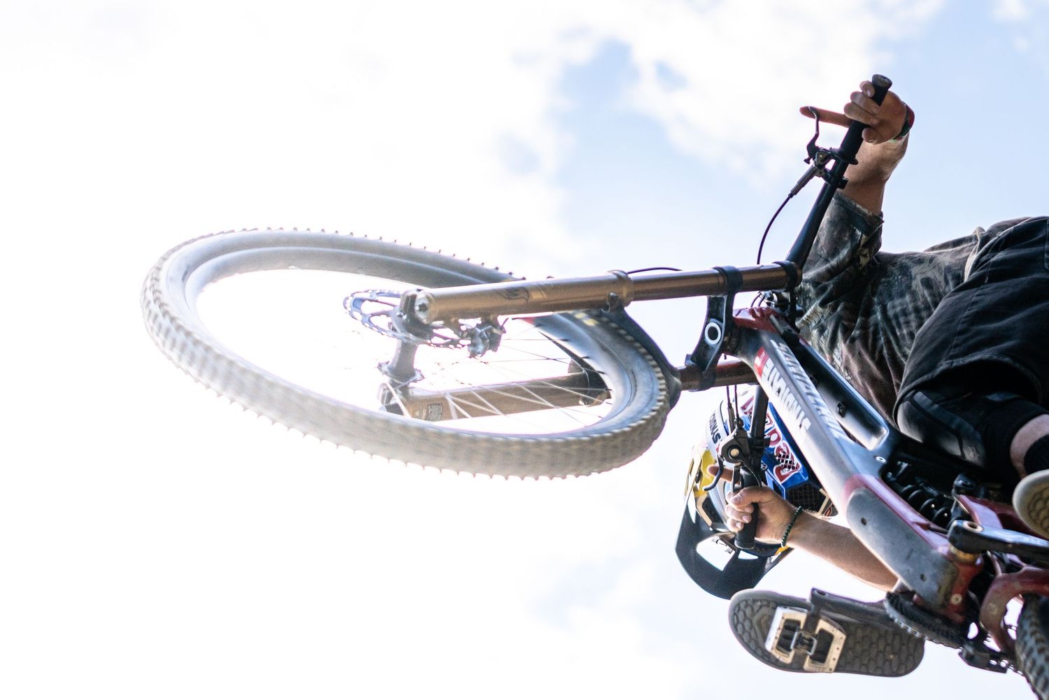 Redbull athlete jumping his bike overhead.