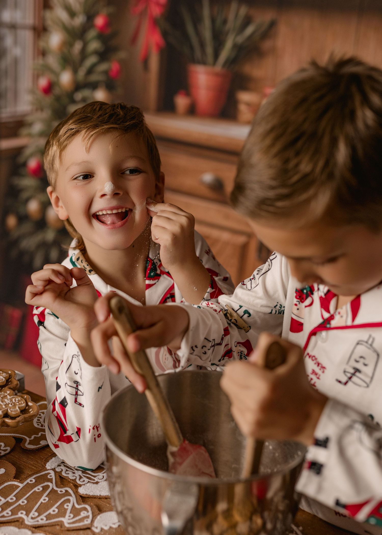 A series of photos showing a child in a heart-patterned shirt decorating Valentine's Day cookies with frosting and sprinkles.