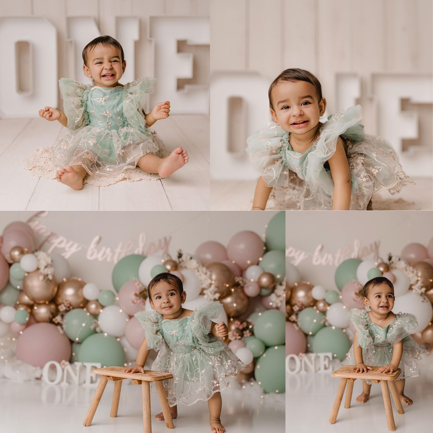 Smiling baby girl in mint green lace dress celebrates first birthday with ONE backdrop and balloon decorations.