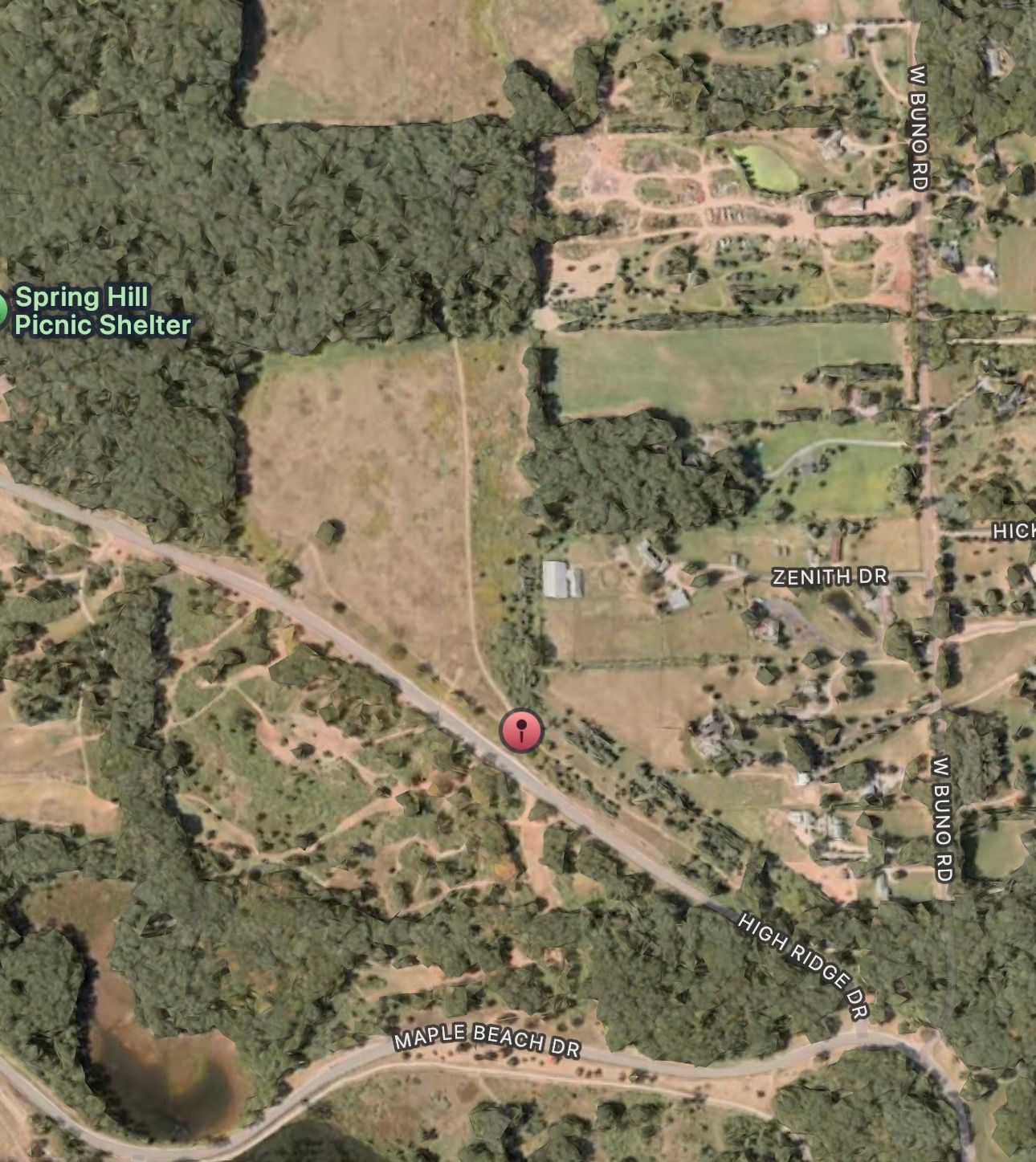 Aerial satellite view of Spring Hill Picnic Shelter surrounded by dense trees, open fields, and winding roads in a rural area.