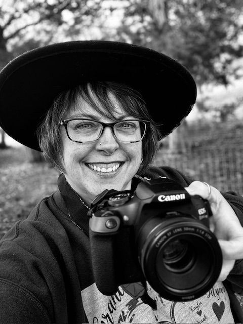 Black and white portrait series showing photographer with Canon camera in various poses wearing a wide-brimmed hat.