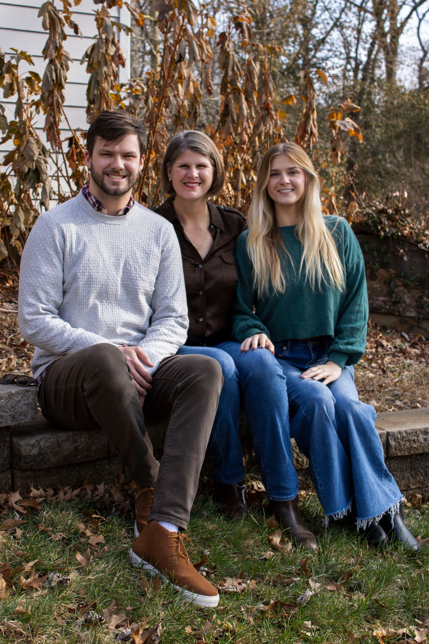 Casual outdoor portraits taken on a rustic bench during autumn.
