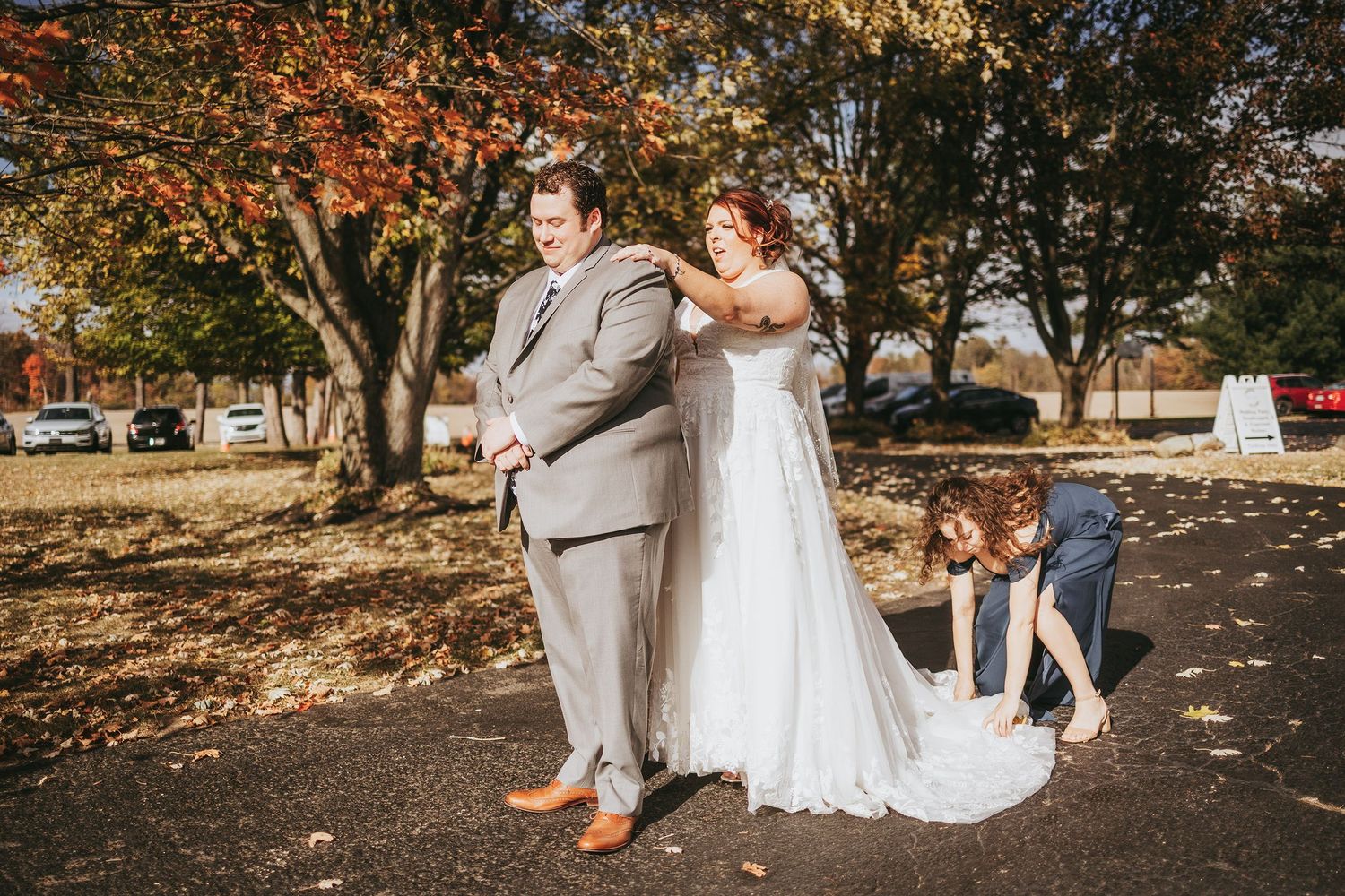 Autumn outdoor wedding portraits with fallen leaves and natural scenery.