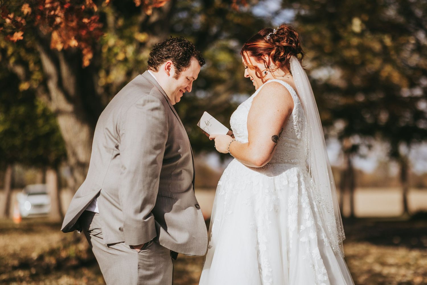 Couple shares intimate moments during autumn wedding photoshoot with orange foliage.