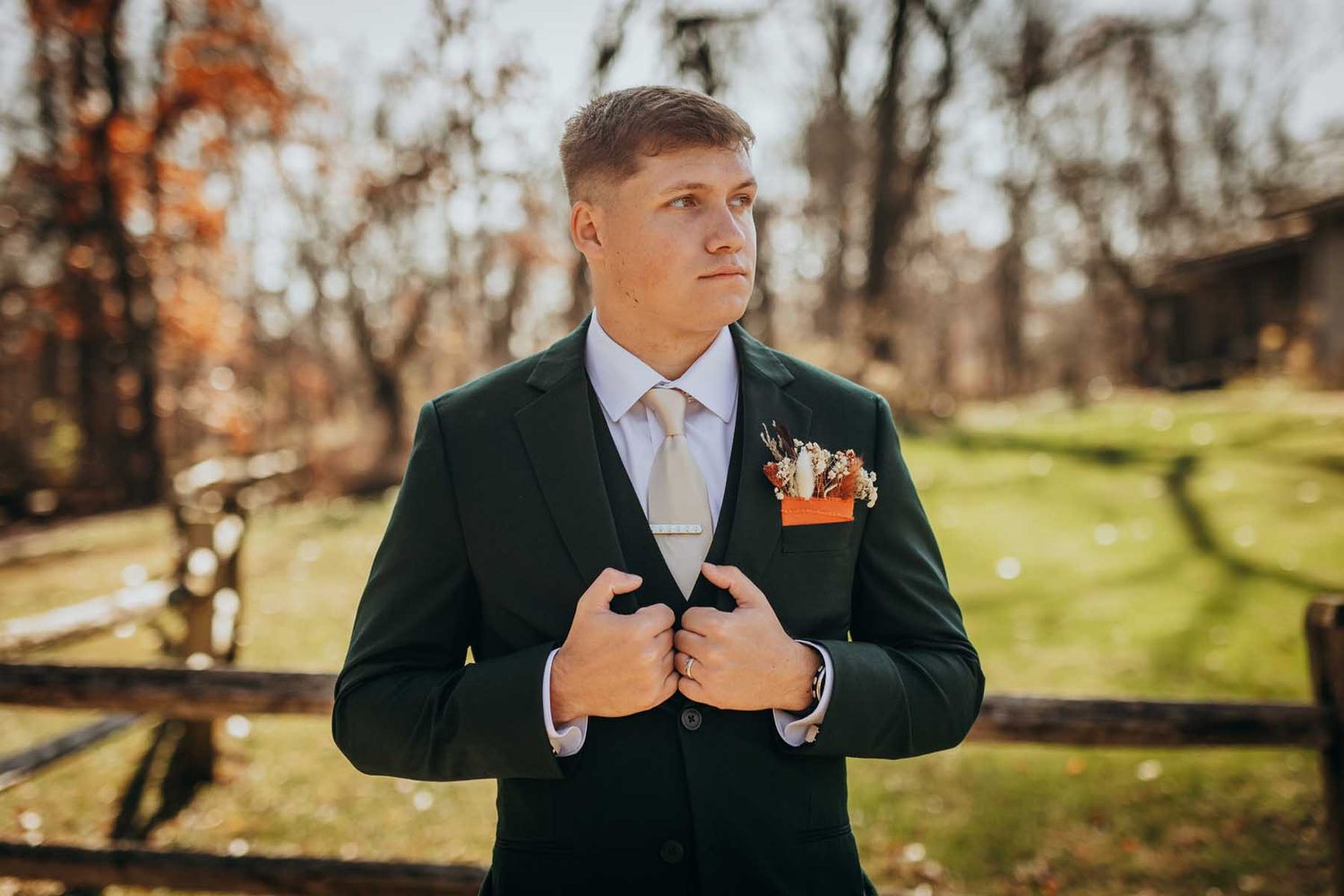 A series of autumn wedding photos showing someone adjusting their suit jacket in a scenic outdoor setting.