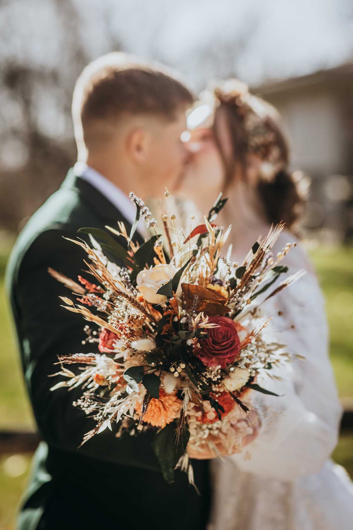 Rustic autumn wedding bouquet with dried flowers, red roses, and wheat stalks shown from different angles.