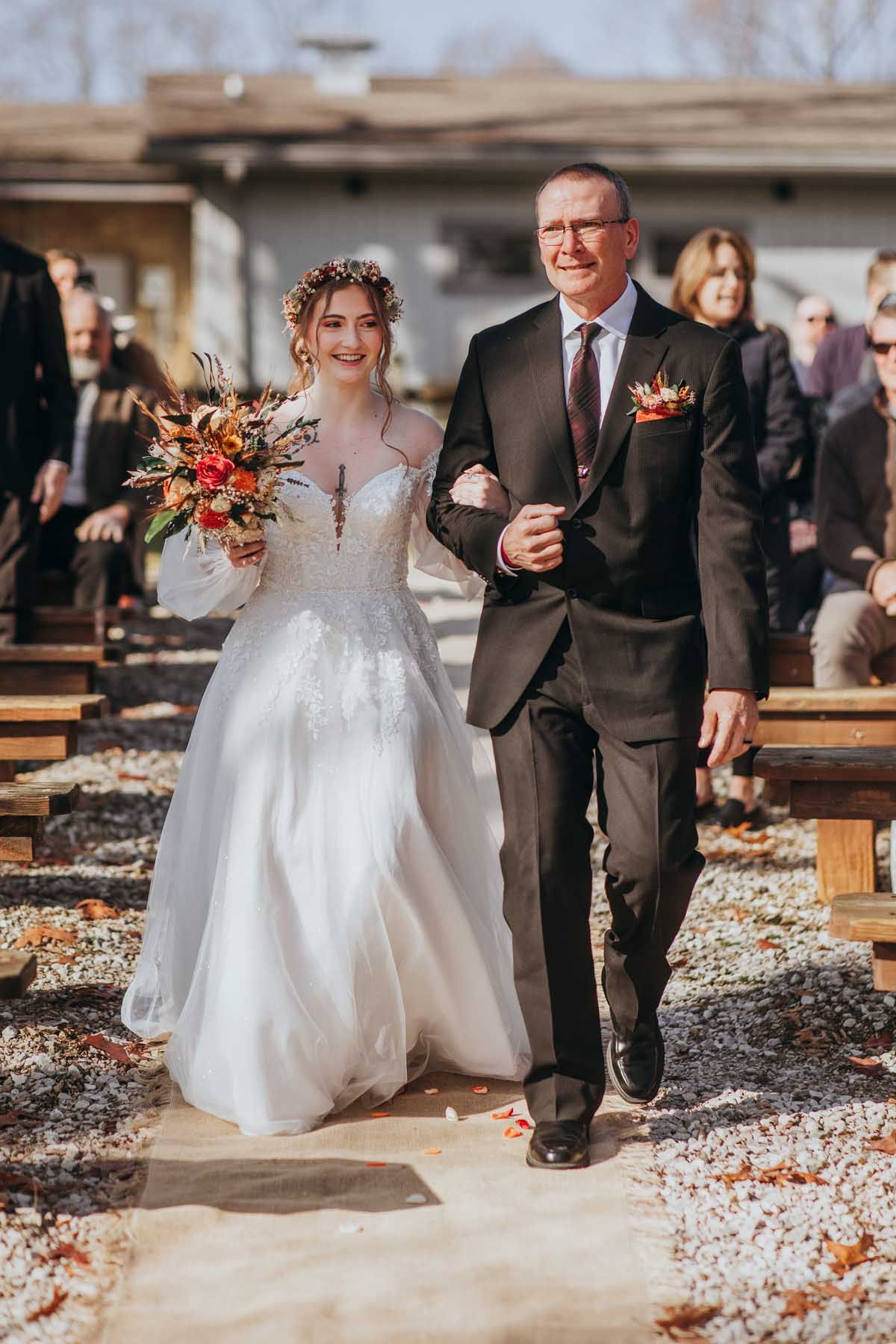 A sequence of wedding photos showing a couple walking through autumn leaves on a path.