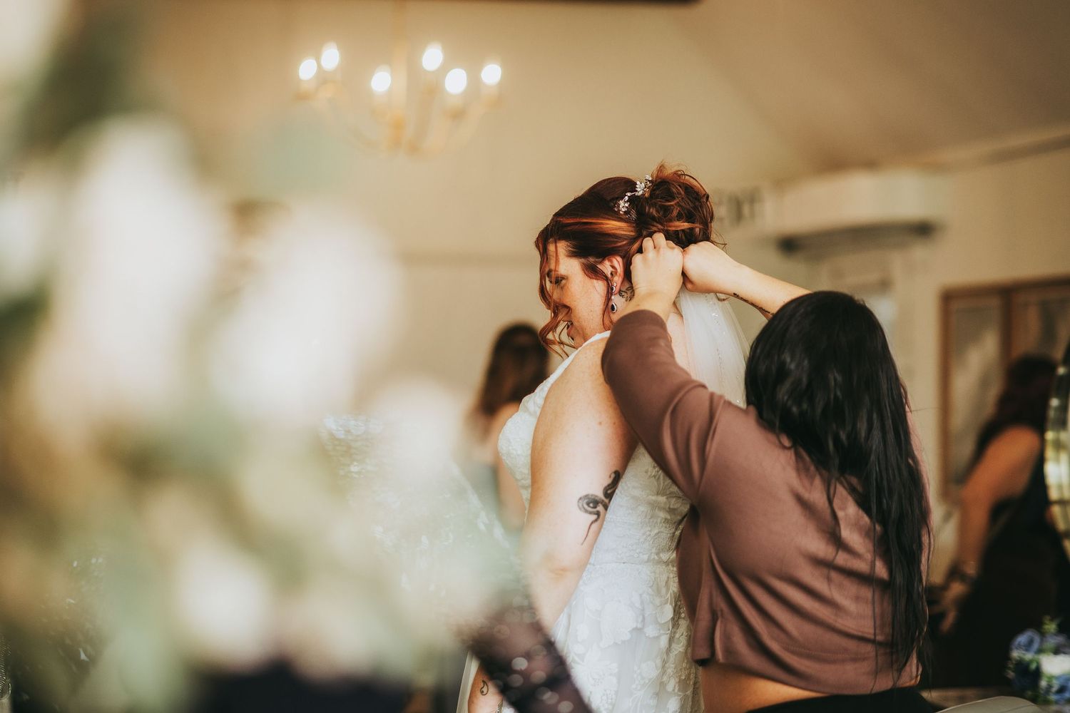 Intimate wedding preparation moments in a softly lit room.
