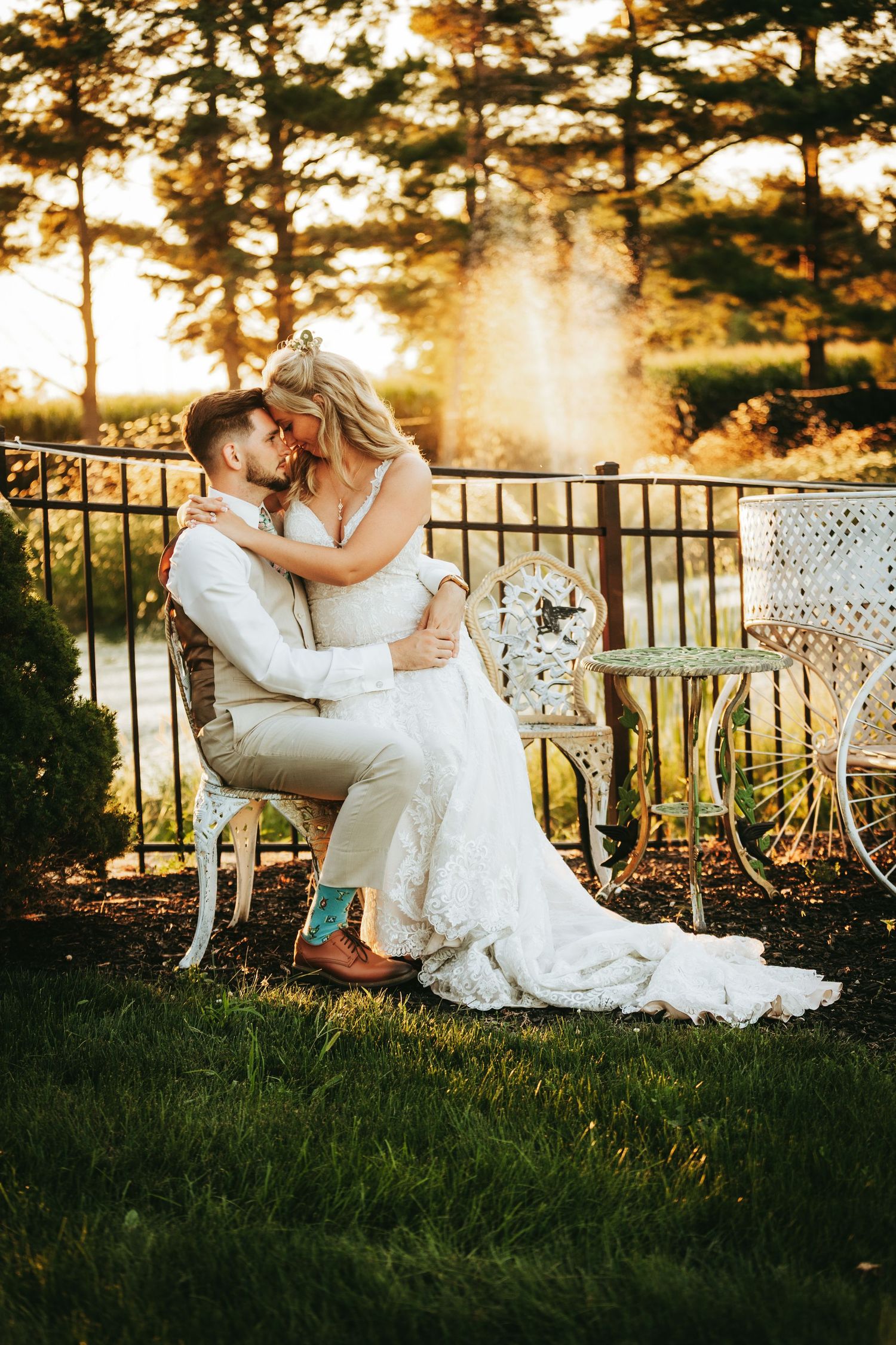 A romantic sunset wedding portrait with vintage decor and golden sunlight streaming through pine trees.