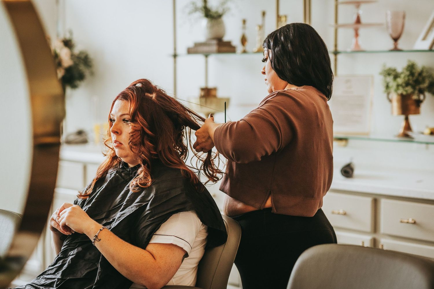 Bridal party getting ready in a bright, modern dressing room.