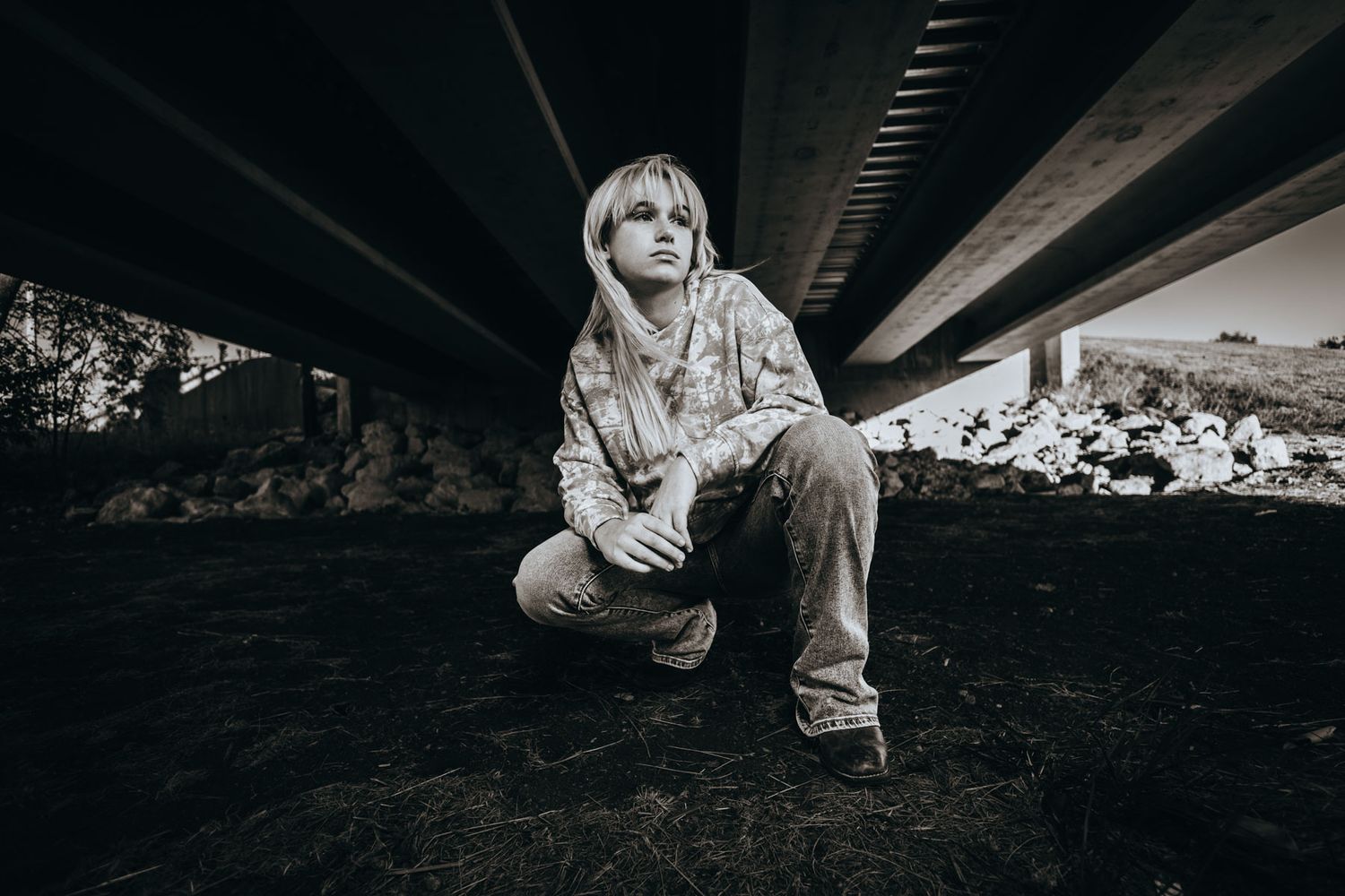 A series of black and white photographs showing climbing shoes and chalk-covered hands gripping rock surfaces.
