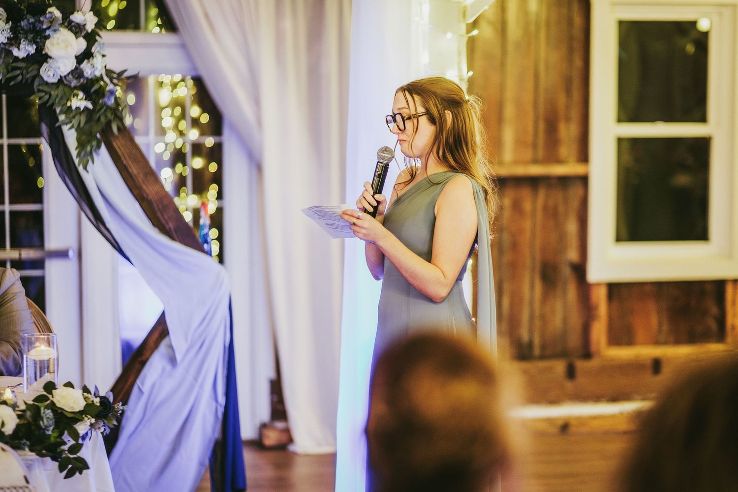 Wedding venue decorated with white drapes and string lights creating a romantic atmosphere.