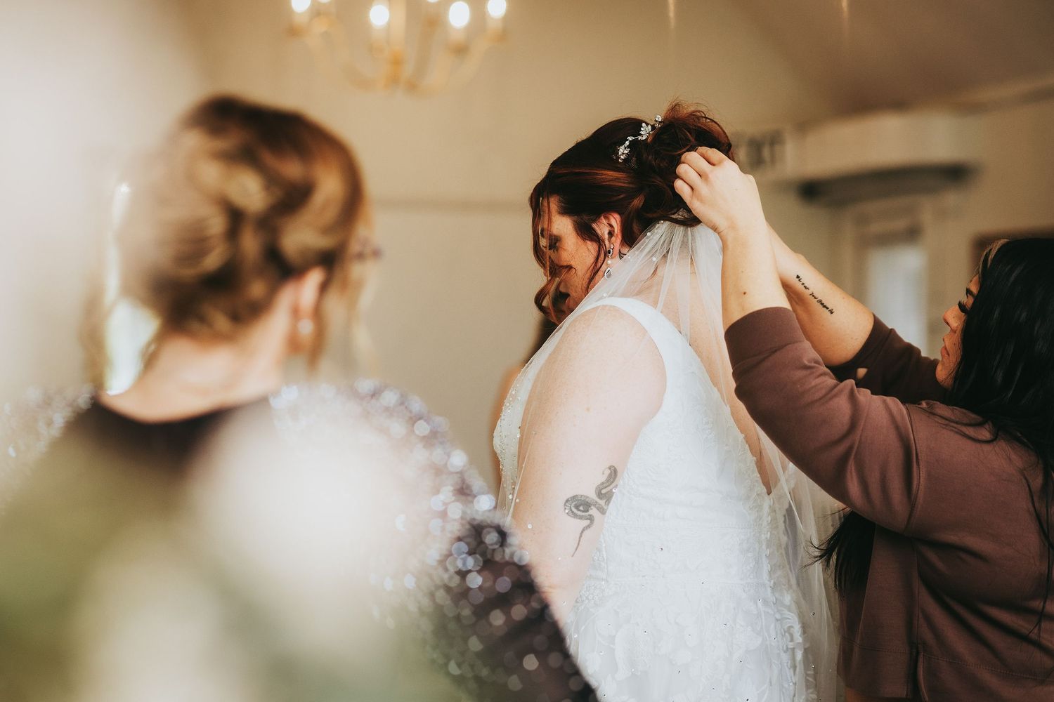 Wedding preparation moments captured in warm indoor lighting.