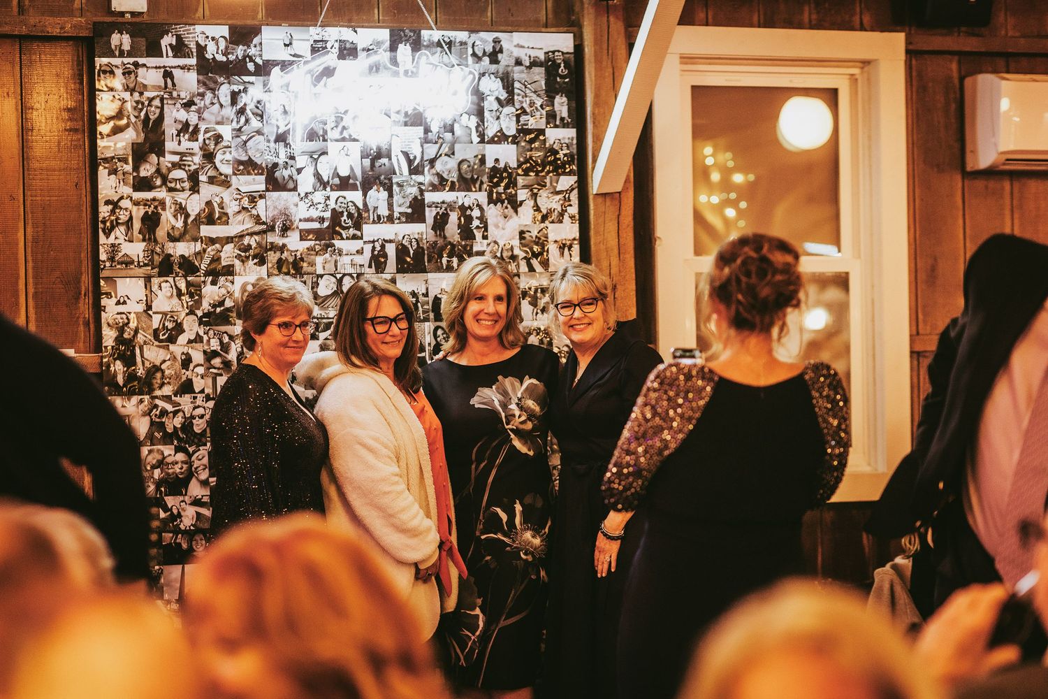 Wedding venue wall decorated with black and white photographs in vintage style.