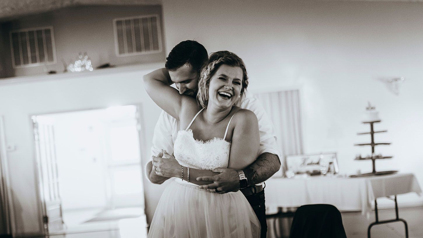 A collection of black and white wedding photos showing intimate moments between a couple during their celebration.