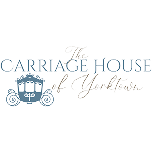 Elegant carriage house logo design in blue with decorative horse-drawn carriage silhouette and classic typography.