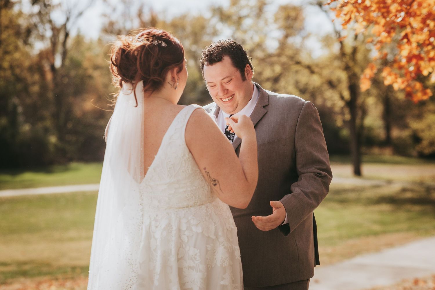 Romantic autumn wedding portraits with golden leaves in background.